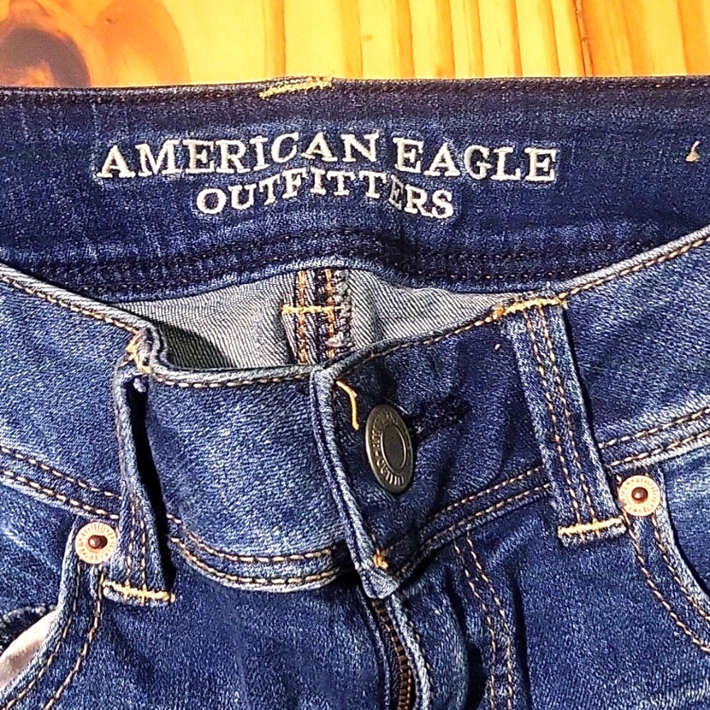 Distressed stretch blue jeans by American Eagle, size 4